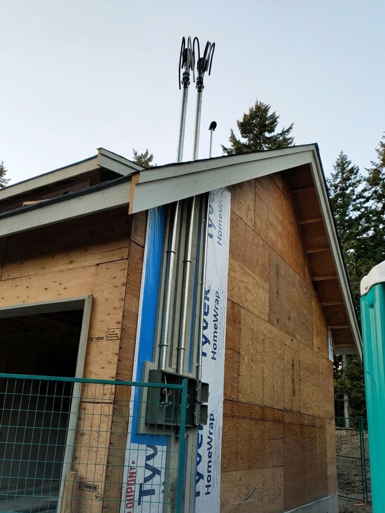 Dual overhead service mast installation on new construction